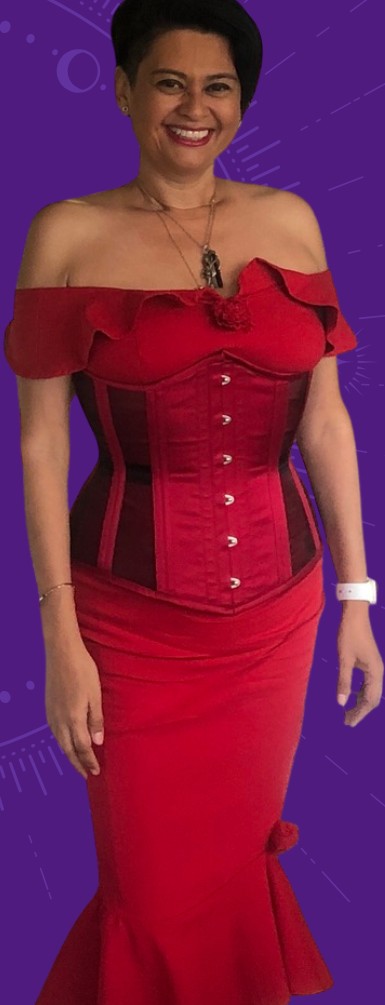 Angelique Luna in a red corset gown, smiling